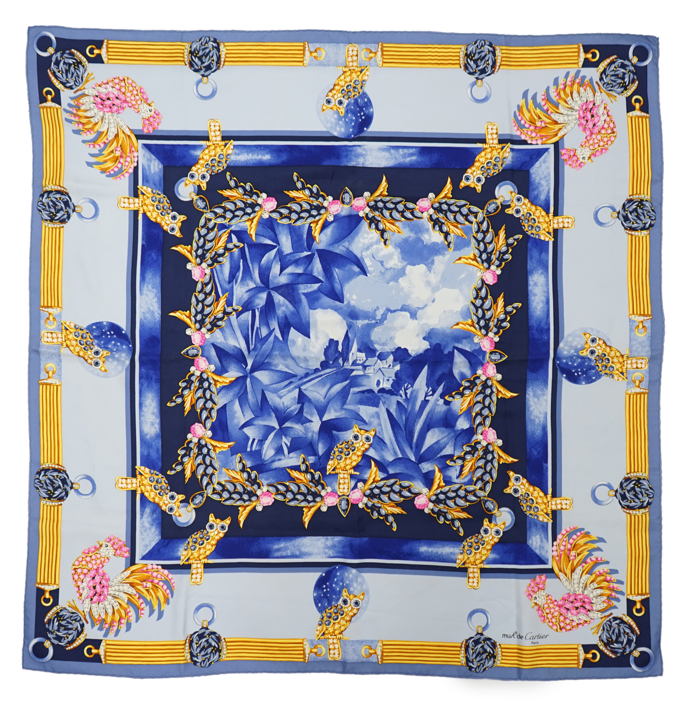 A Must de Cartier vintage silk scarf with owls in sapphire and a Must de Cartier silk scarf with figure clock pattern, 87cm x 85cm